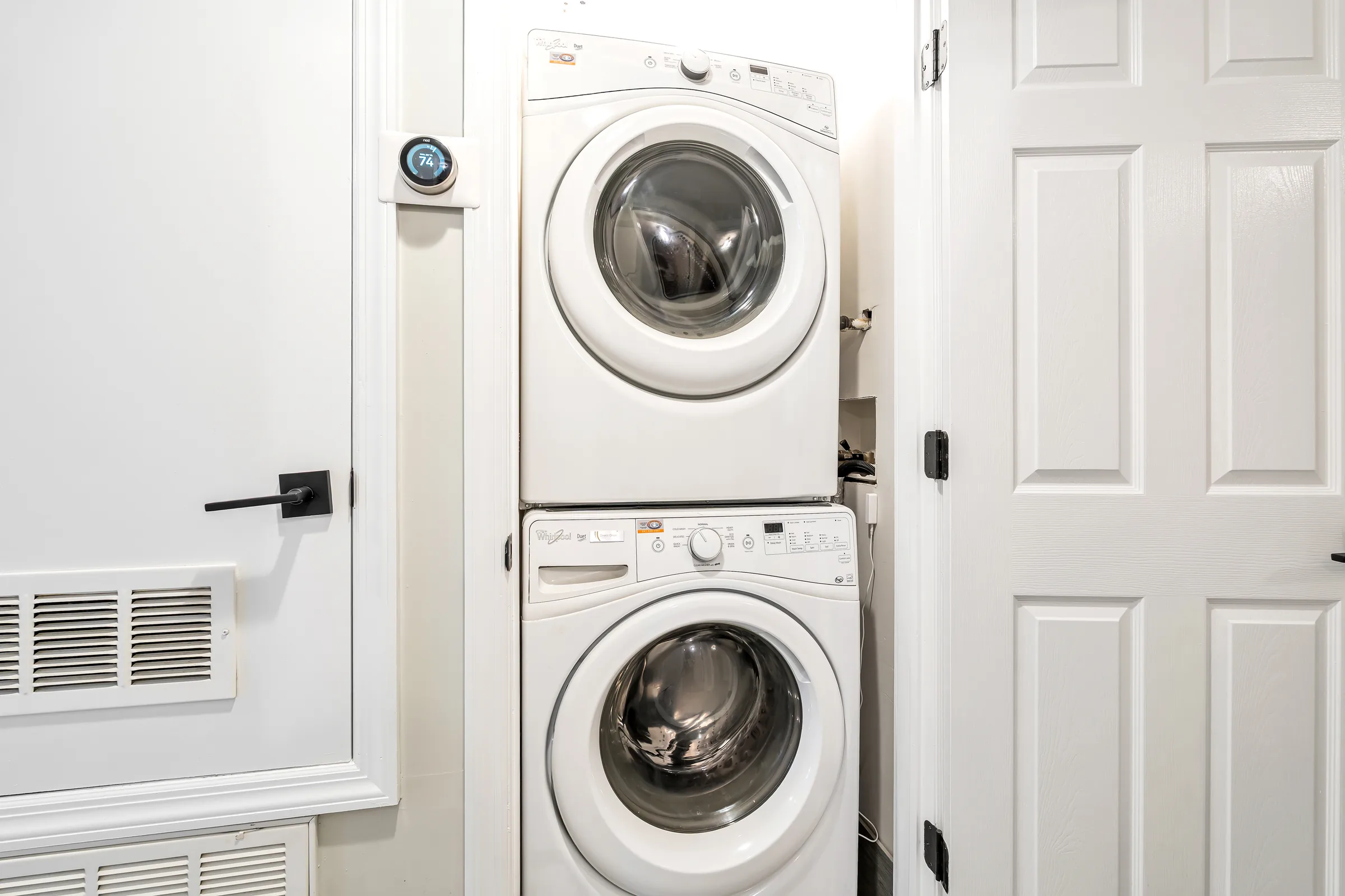 Stacked washer and dryer in the hallway at Apartment B, 829 Garden Street.