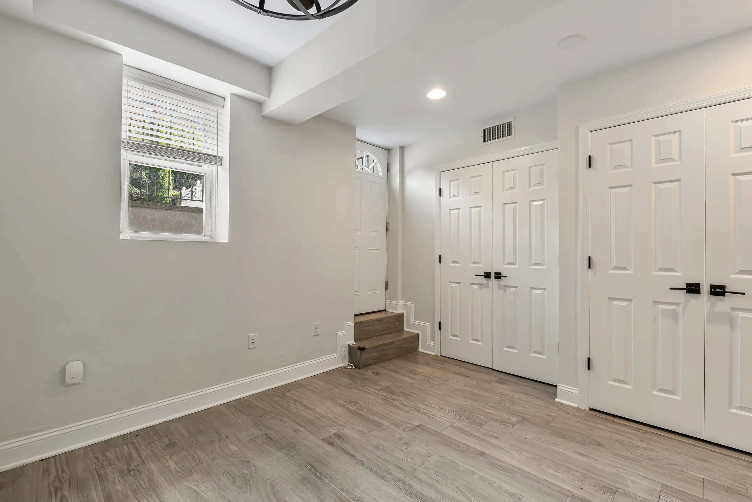Primary bedroom closet doors and window at 829 Garden Street, Apartment B.