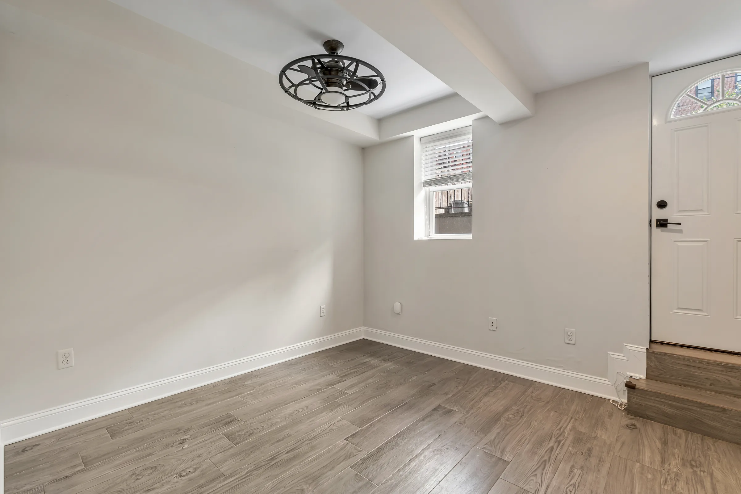 Primary bedroom with a door to the patio and a window at Apartment B, 829 Garden Street.