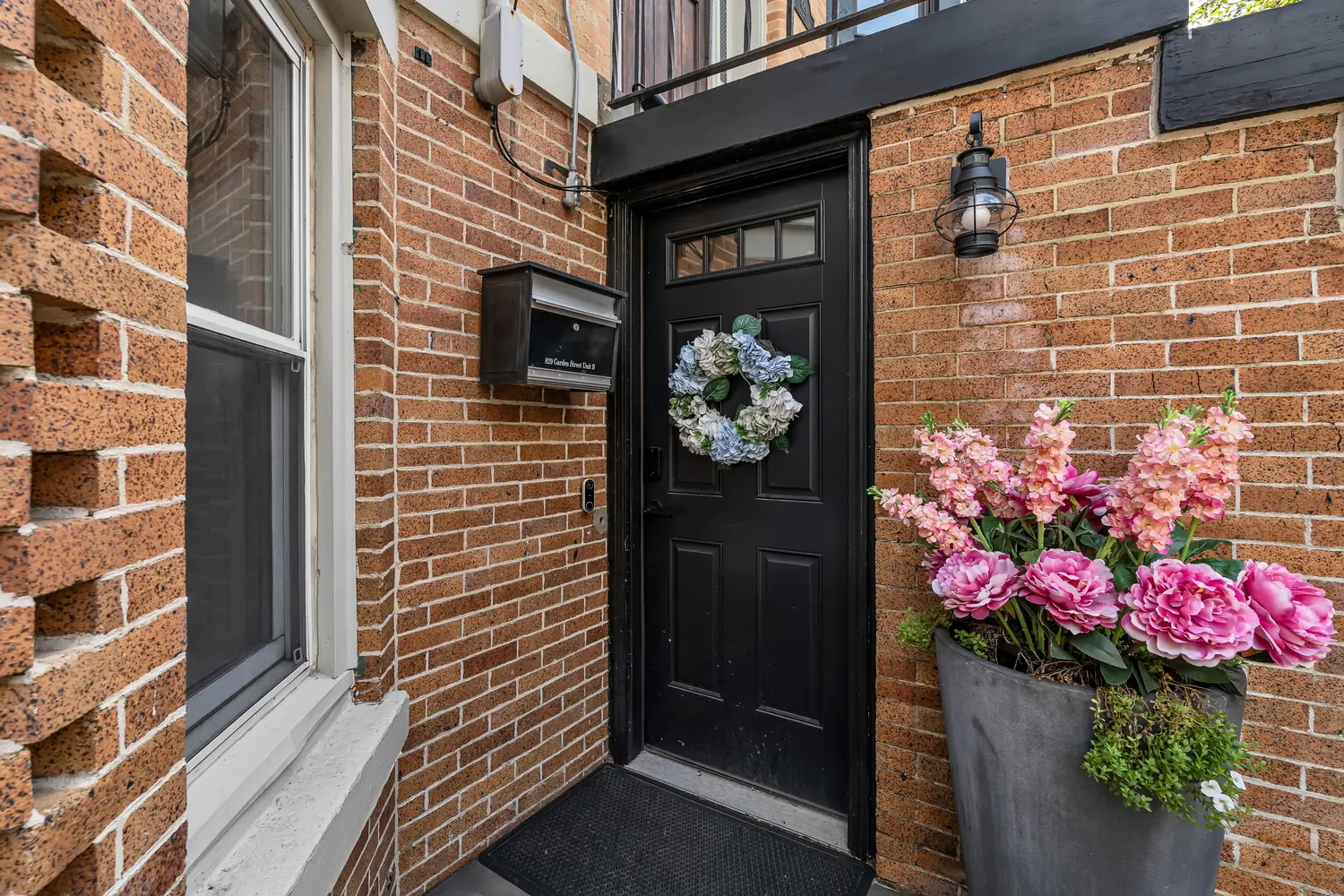 Black door at the private garden-level entrance of 829 Garden Street, Apartment B.