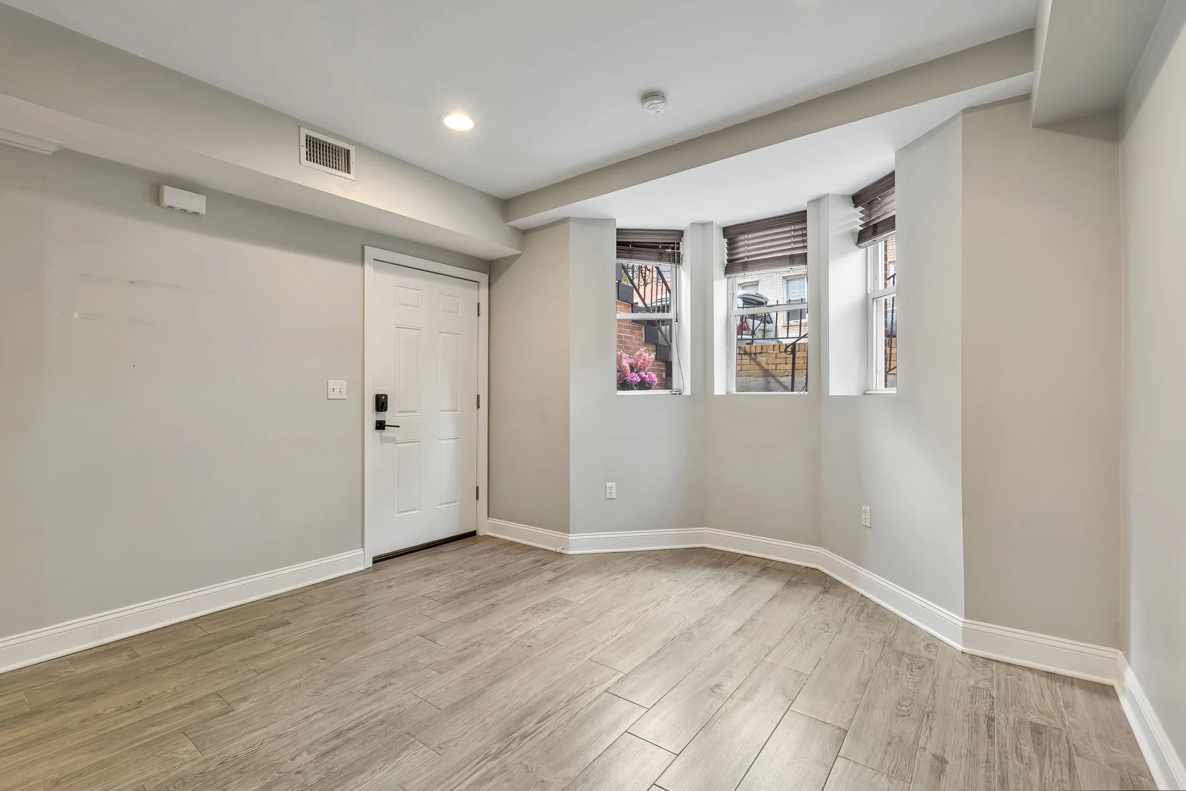 Bay windows at the front of the living room, Apartment B, Uptown Hoboken.