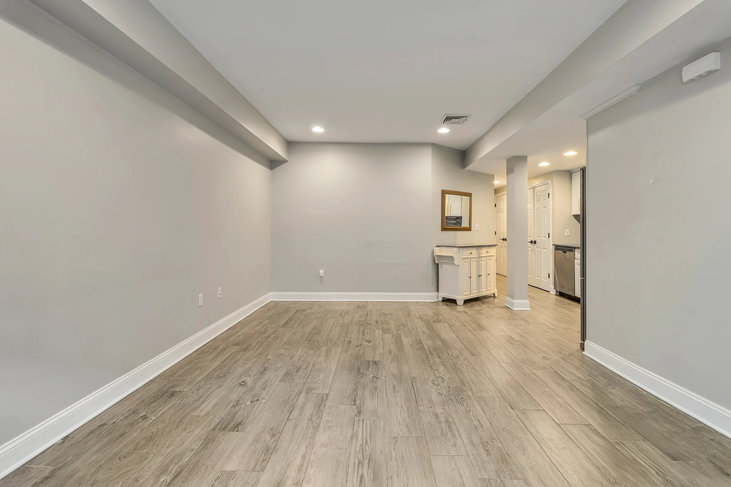 Empty living room with light wood-look flooring at Apartment B, 829 Garden Street, Uptown Hoboken.